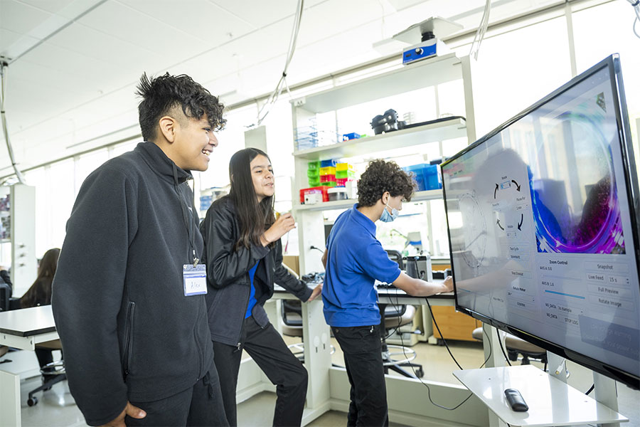 Participants observe the computer interface of the tool where they can modify the environment in which a plant will grow.
