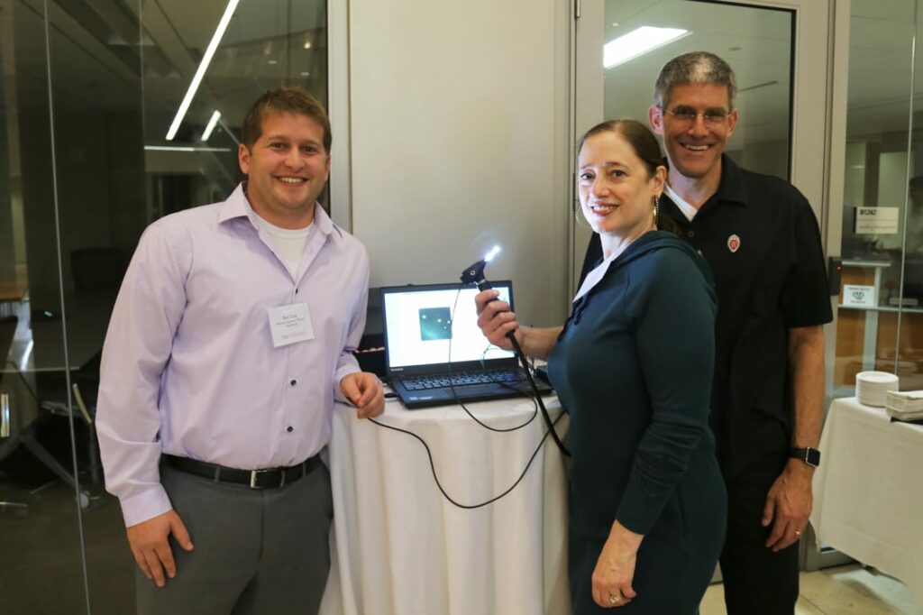 Ben Cox (left) of the Morgridge Medical Engineering team, with Karen Walsh and James Berbee, helped develop the initial prototype of the new otoscope. 