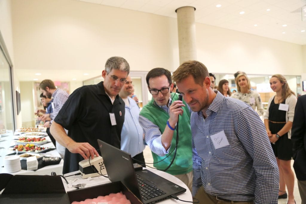 Dr. James Berbee with Dr. Mike Steuerwald and Dr. Chris Stahmer of UW Emergency Medicine test out the newly developed otoscope device. 