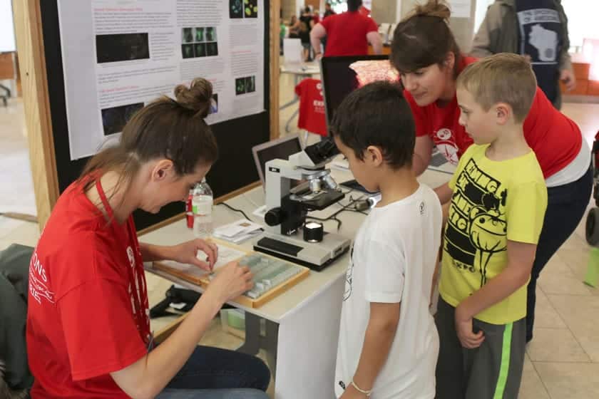 Ellen Arena (right) and Kristy Wendt demonstrate a microscopy activity during a Science Expeditions event at the Discovery Building.