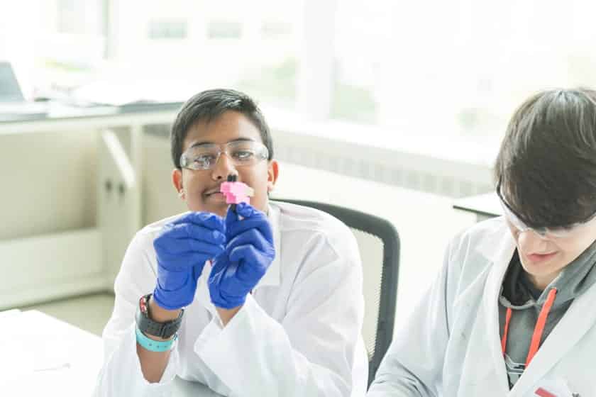 Students model microfluidics technologies by creating interlocking structures with custom blocks. The blocks are designed with minuscule channels in which liquid flows through.