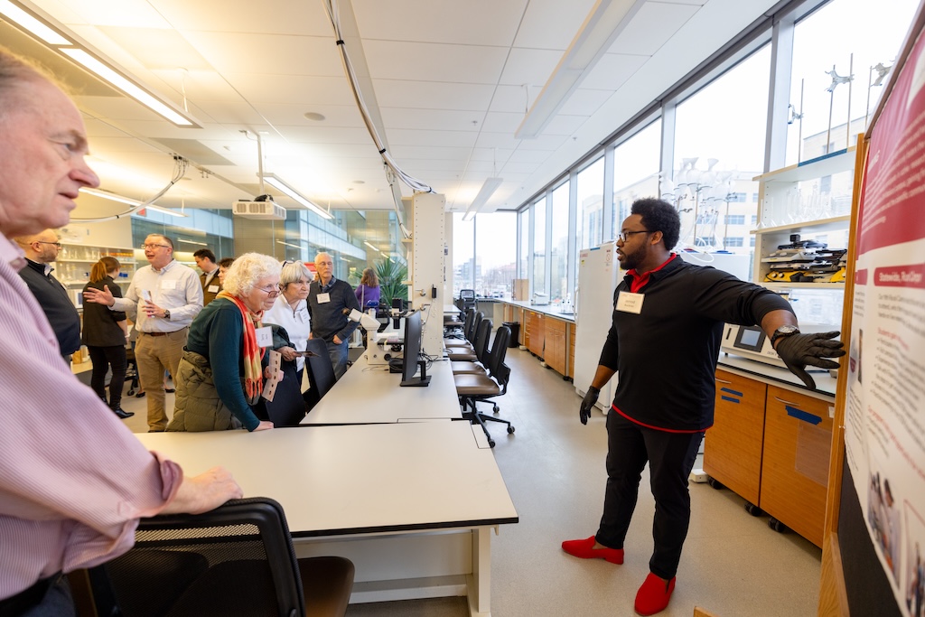 Jerrod Buckner coaches attendees on how to be more confident in their identities as scientists and science ambassadors while performing a stem cell experiment.