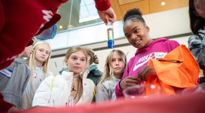 Students looking at a vial