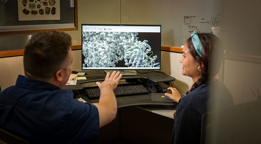 Tim Grant and Roma Broadberry at a computer