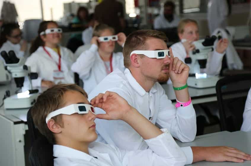 Campers wear 3-D glasses to view scientific images created with a lightsheet microscope. Activity presented by the Jan Huisken Lab.