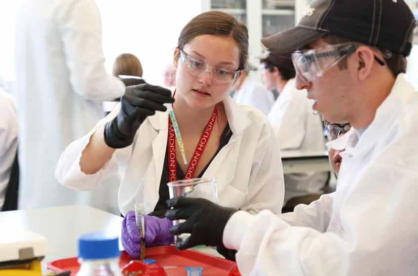 Two students prepare glitter 