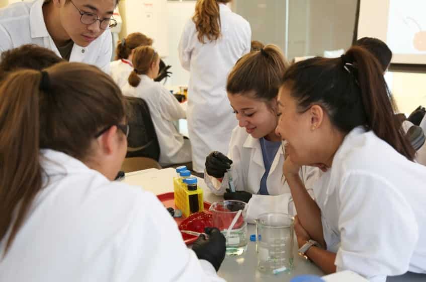 Campers work with a gelatin heart and glitter 