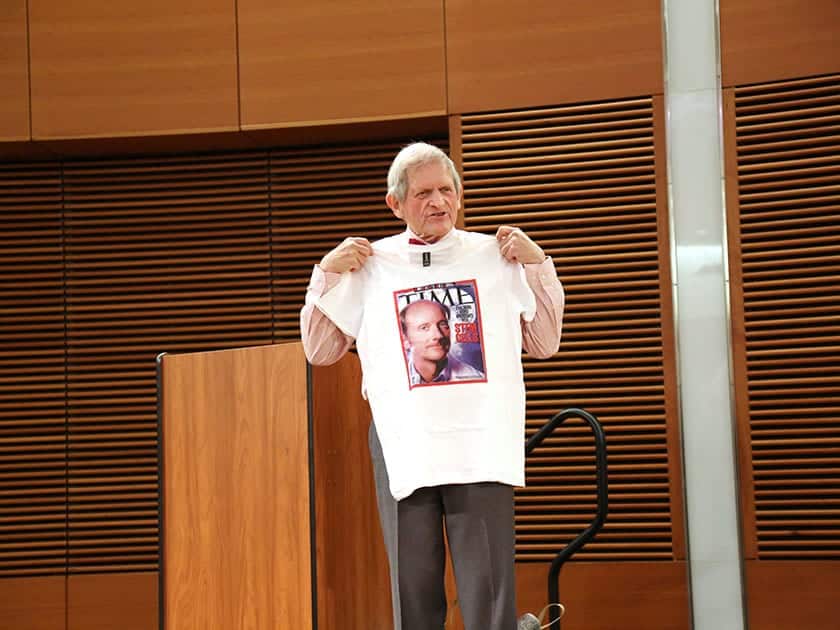 John Morgridge presents a t-shirt honoring the August 2001 TIME Magazine cover in which Jamie Thomson and stem cell research was featured.